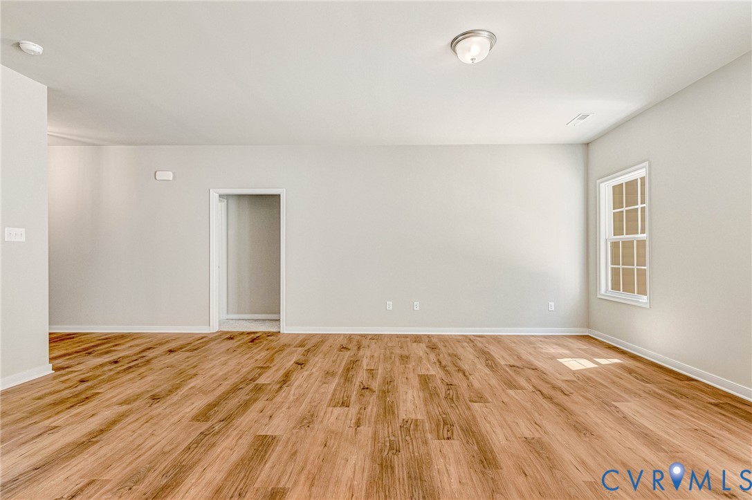 8355 Patrick Henry Boulevard Mechanicsville, VA 23116 - Photo 25 of 48 a view of empty room with wooden floor and fan