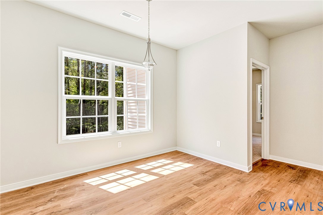 8355 Patrick Henry Boulevard Mechanicsville, VA 23116 - Photo 27 of 48 a view of empty room with wooden floor and fan