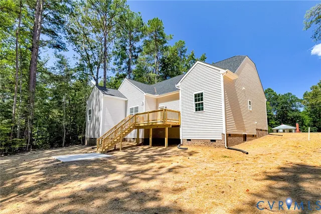 a kitchen with stainless steel appliances granite countertop a stove top oven a sink dishwasher a dining table and chairs with wooden floor