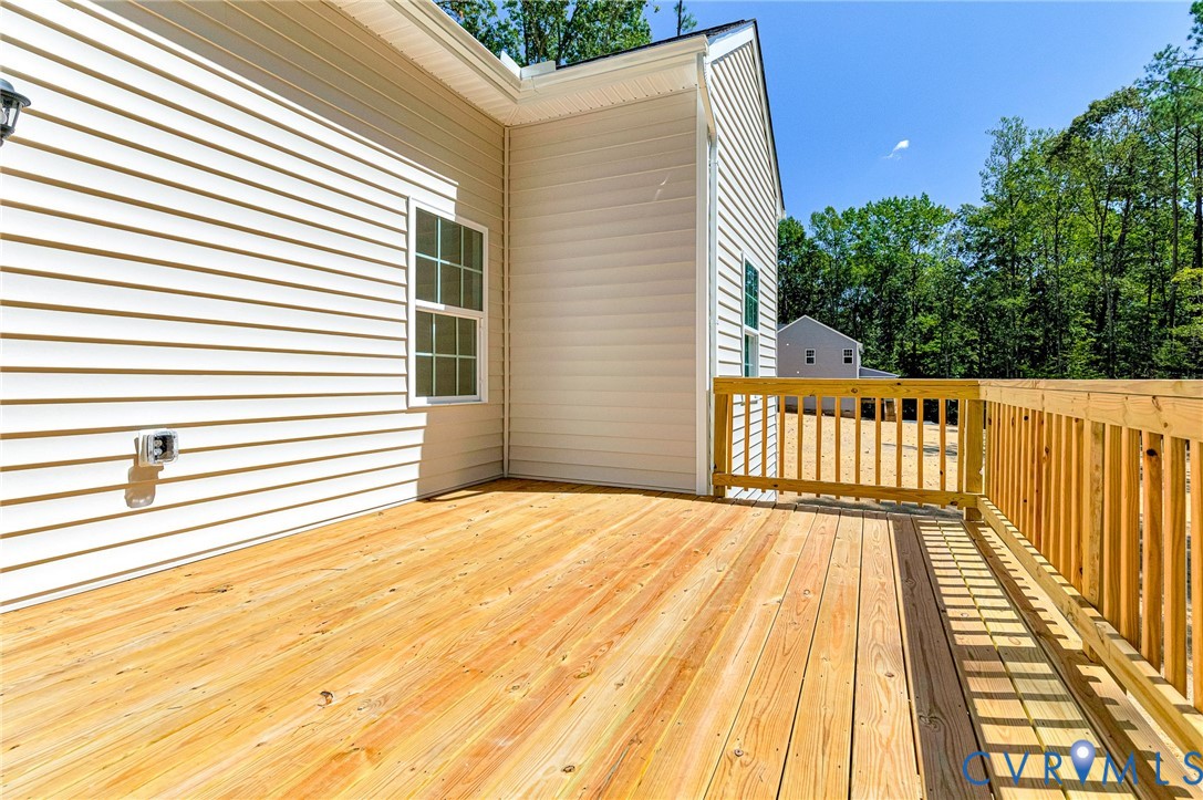 8355 Patrick Henry Boulevard Mechanicsville, VA 23116 - Photo 47 of 48 a view of a balcony with wooden floor and fence