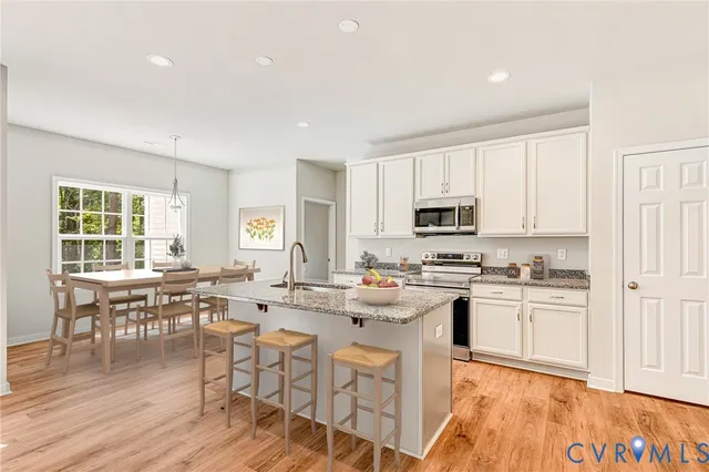 a view of kitchen with wooden floor and electronic appliances