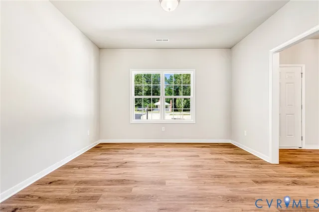 a kitchen with stainless steel appliances granite countertop a stove a sink dishwasher and a microwave oven with wooden floor