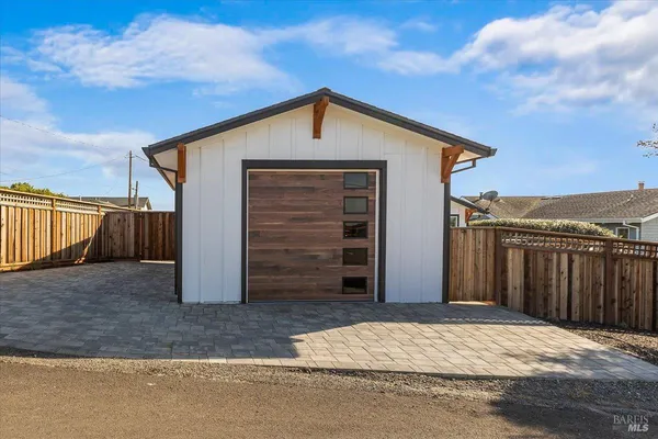 a view of a house with wooden fence