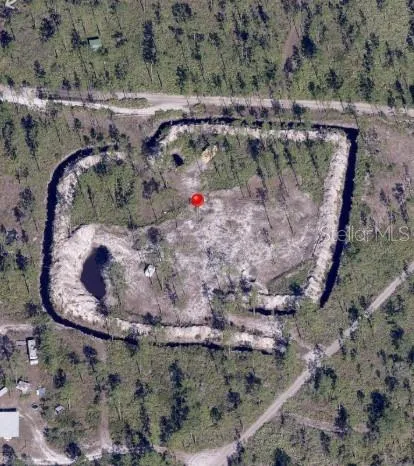 a view of dirt yard with a large trees