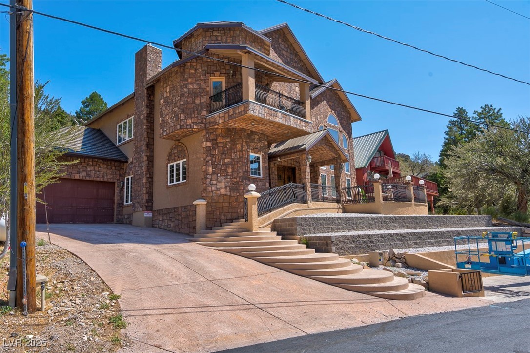 View of front of property with a garage and a balcony