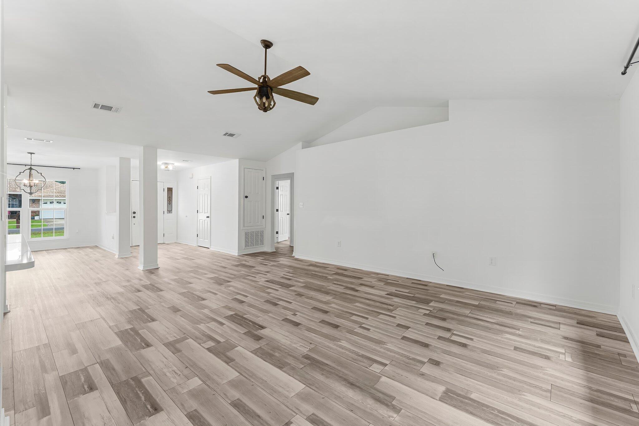 162 Beacon Way Santa Rosa Beach, FL 32459 - Photo 10 of 41 a view of a livingroom with a hardwood floor and a ceiling fan