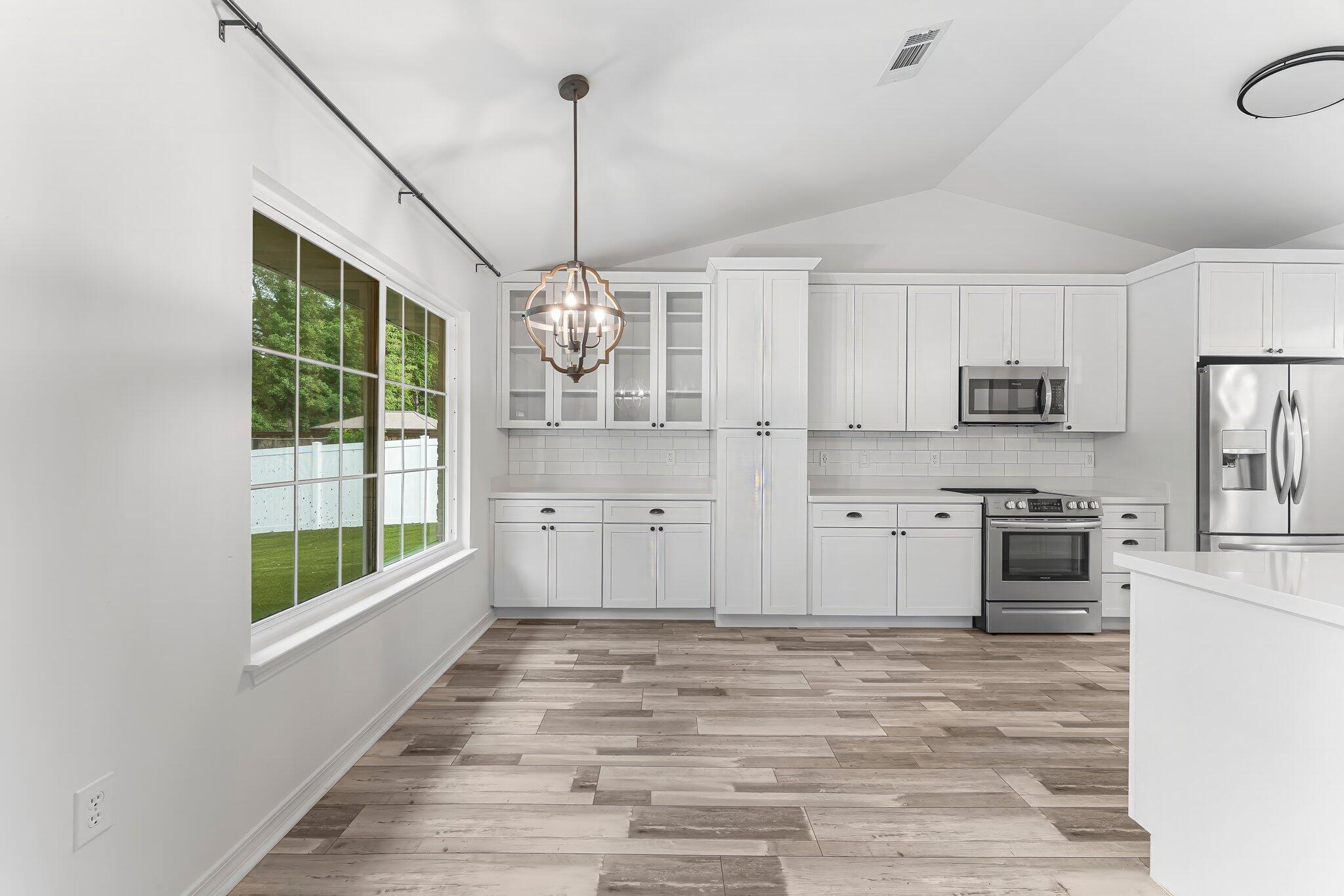 162 Beacon Way Santa Rosa Beach, FL 32459 - Photo 11 of 41 a large kitchen with kitchen island a counter space a sink stainless steel appliances and cabinets
