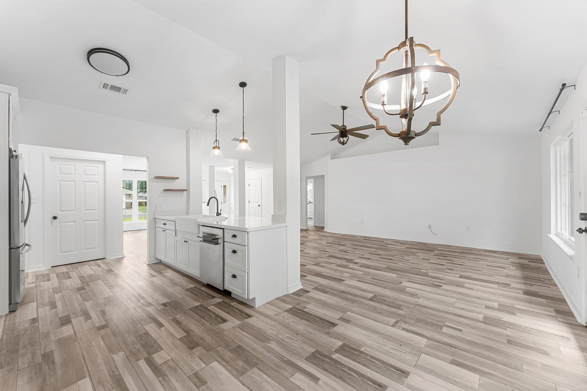162 Beacon Way Santa Rosa Beach, FL 32459 - Photo 12 of 41 a view of kitchen and empty room with wooden floor