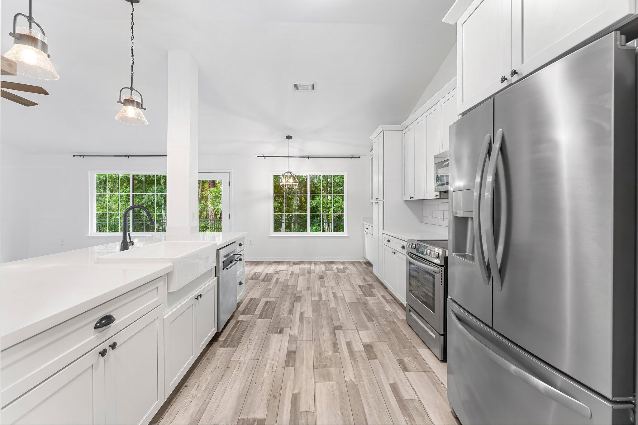 162 Beacon Way Santa Rosa Beach, FL 32459 - Photo 13 of 41 a kitchen with stainless steel appliances a refrigerator sink and cabinets