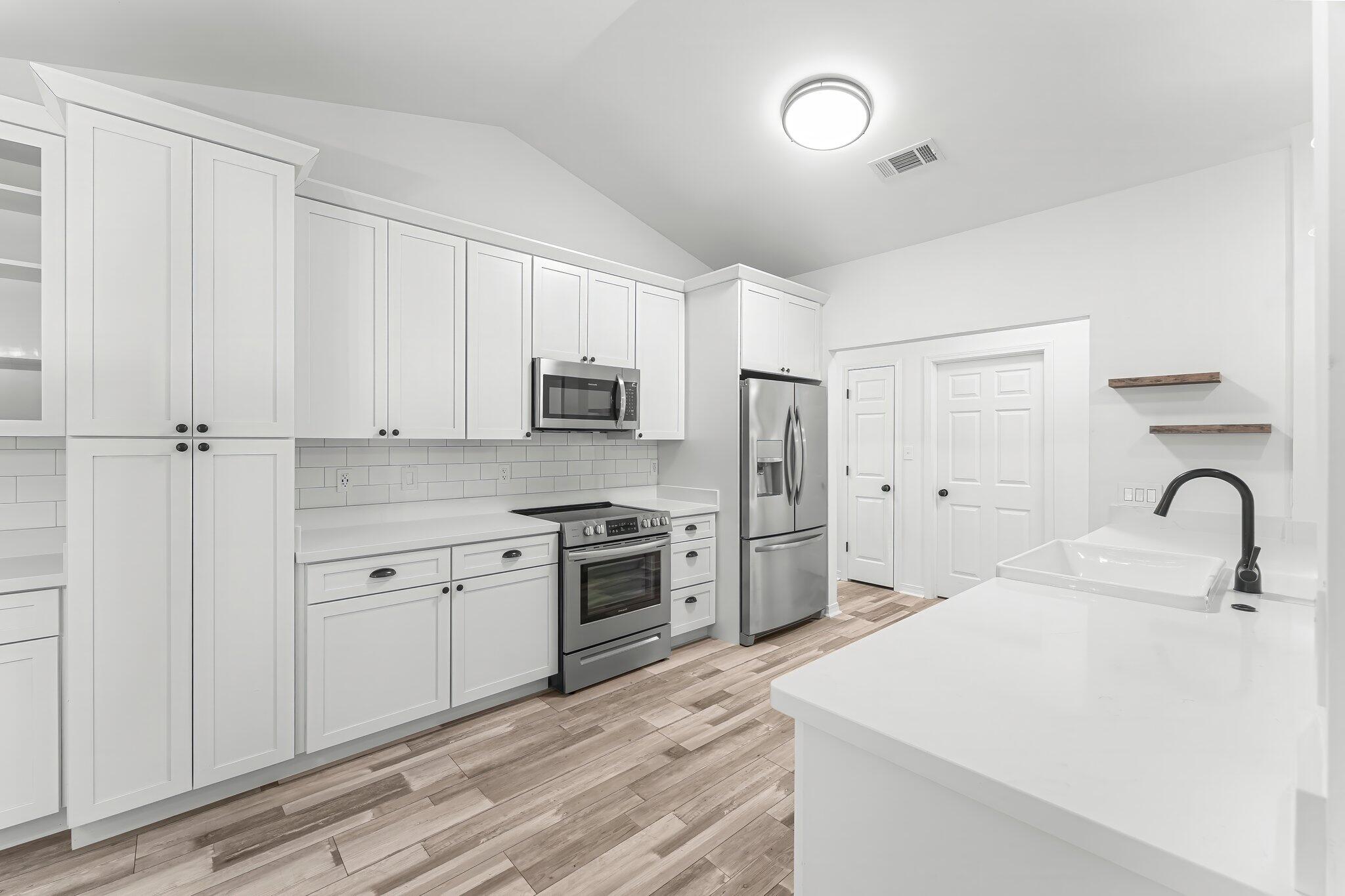 162 Beacon Way Santa Rosa Beach, FL 32459 - Photo 14 of 41 a kitchen with stainless steel appliances granite countertop a stove a sink dishwasher and a refrigerator