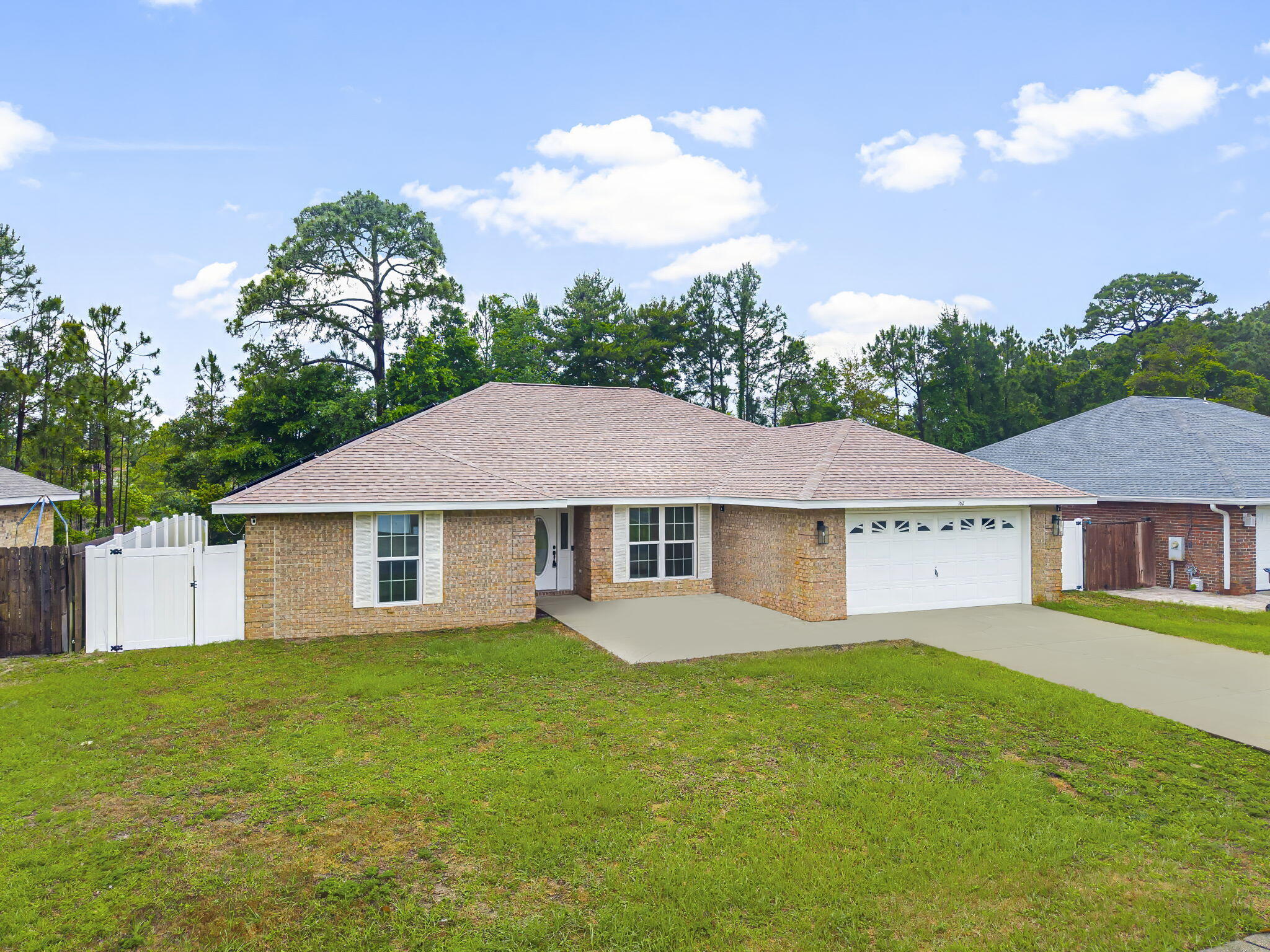 162 Beacon Way Santa Rosa Beach, FL 32459 - Photo 2 of 41 a view of a yard in front of a house with a large tree