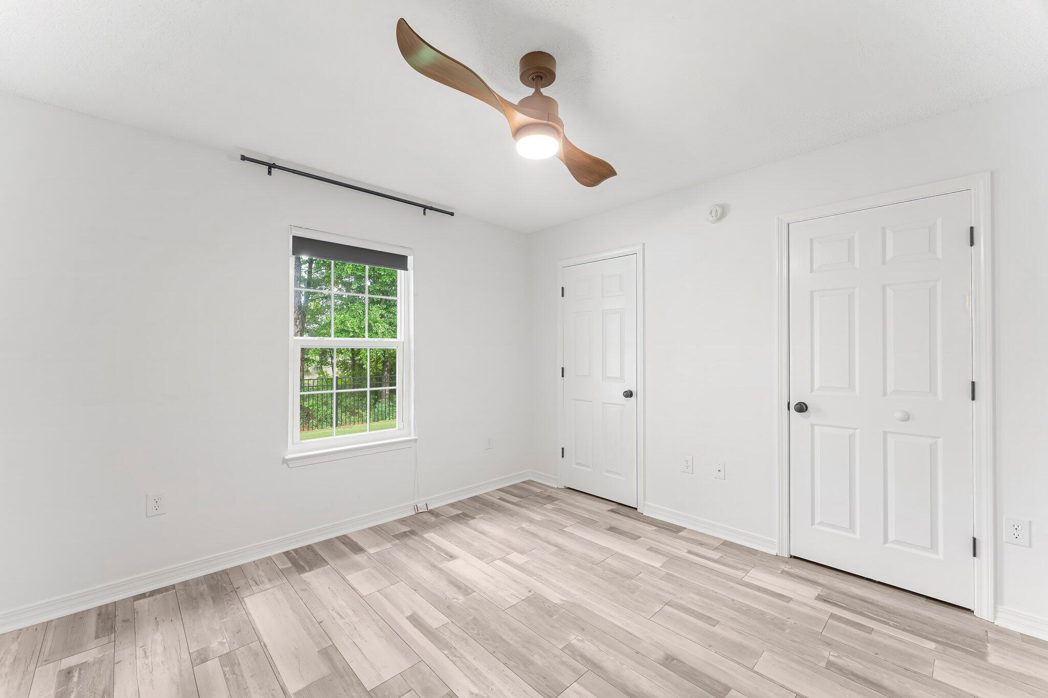 162 Beacon Way Santa Rosa Beach, FL 32459 - Photo 22 of 41 an empty room with wooden floor ceiling fan and windows