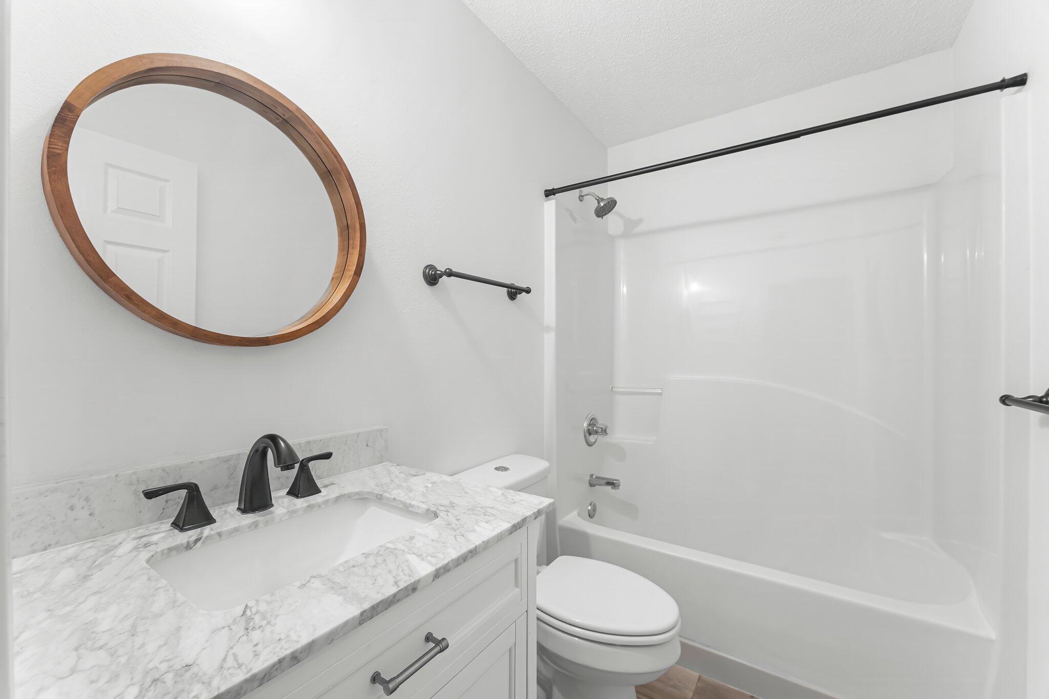 162 Beacon Way Santa Rosa Beach, FL 32459 - Photo 23 of 41 a bathroom with a granite countertop sink toilet and a mirror