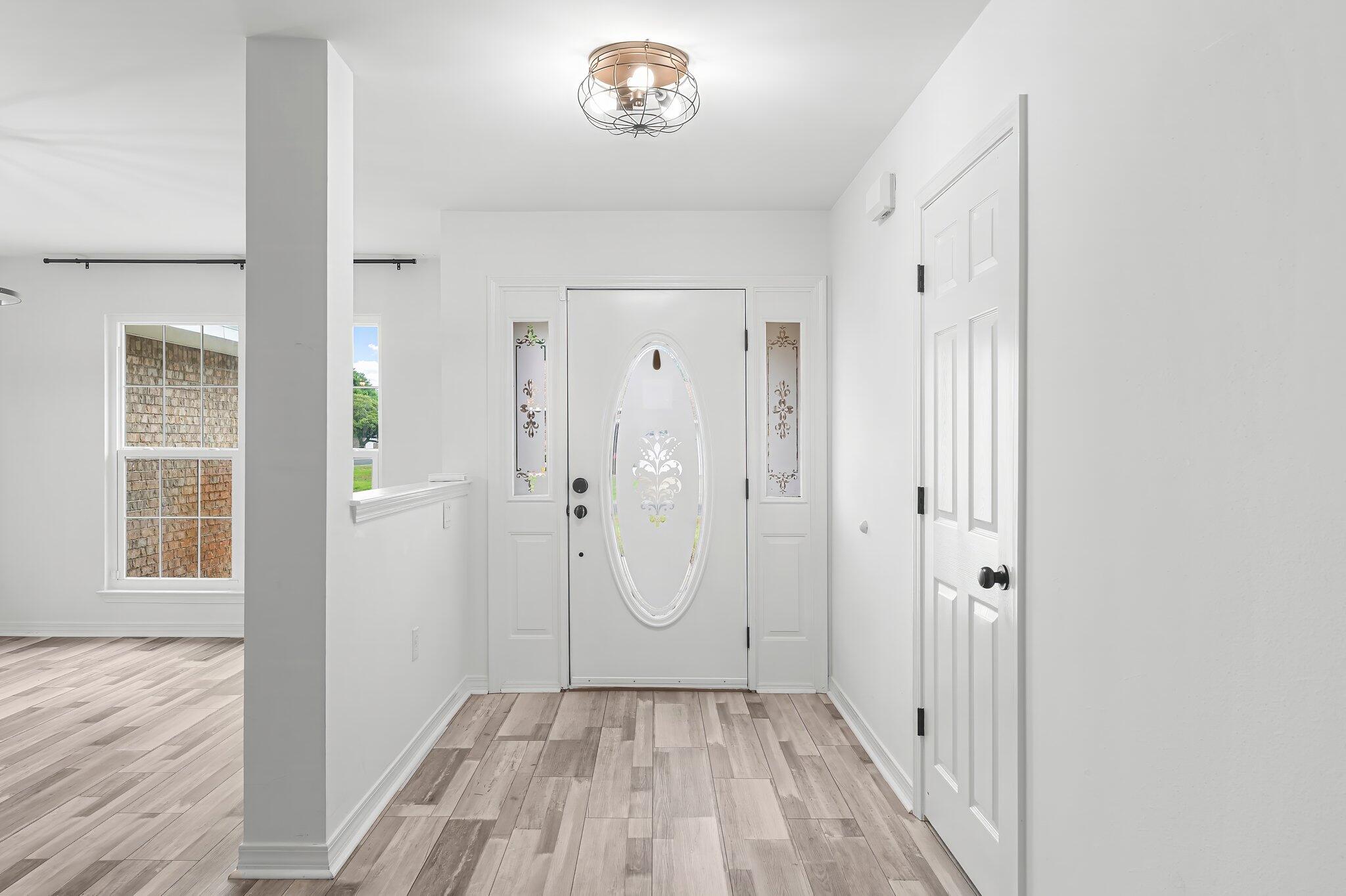 162 Beacon Way Santa Rosa Beach, FL 32459 - Photo 4 of 41 a view of a hallway with wooden floor and a bathroom