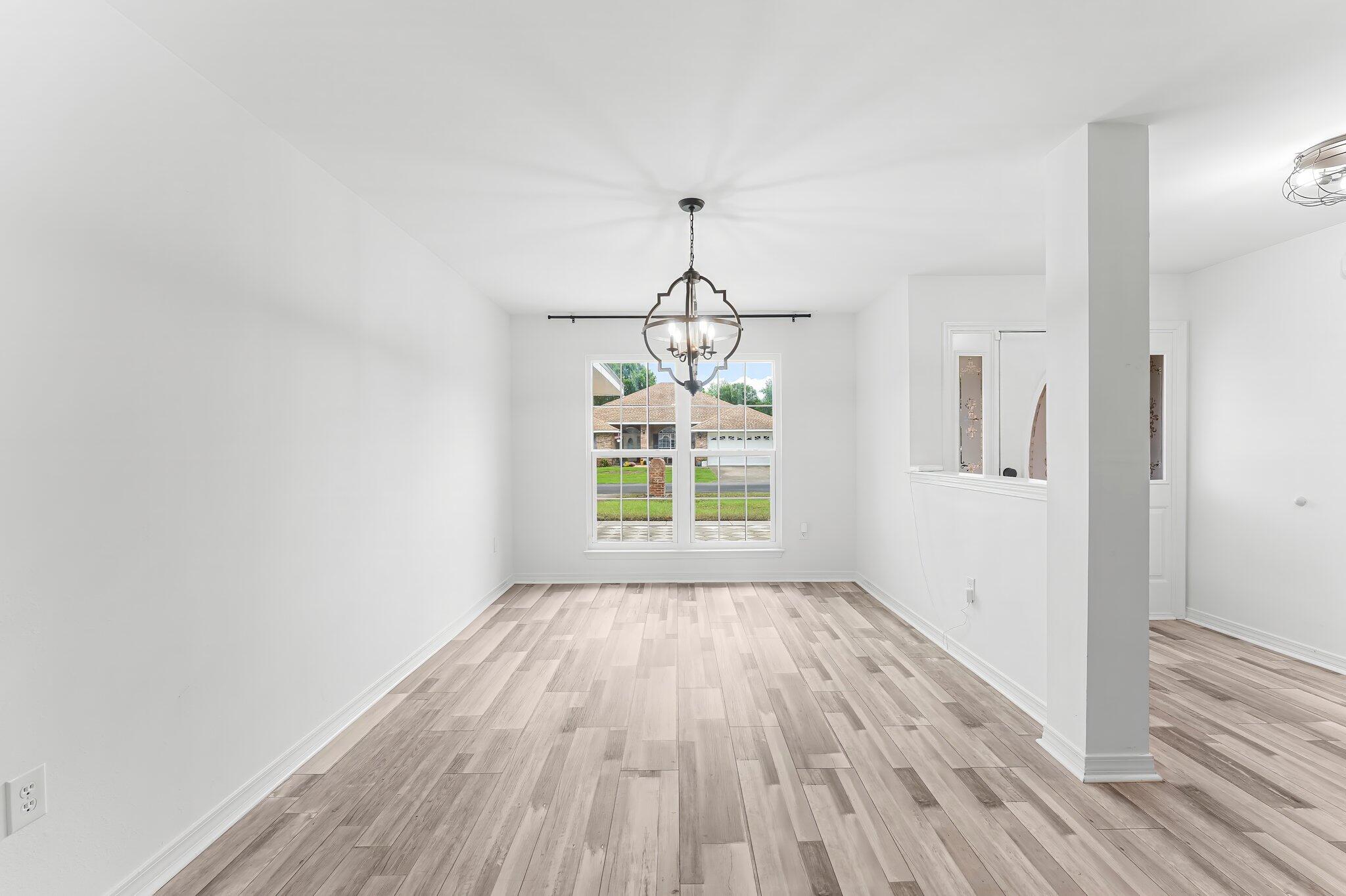 162 Beacon Way Santa Rosa Beach, FL 32459 - Photo 5 of 41 a view of empty room with wooden floor and fan