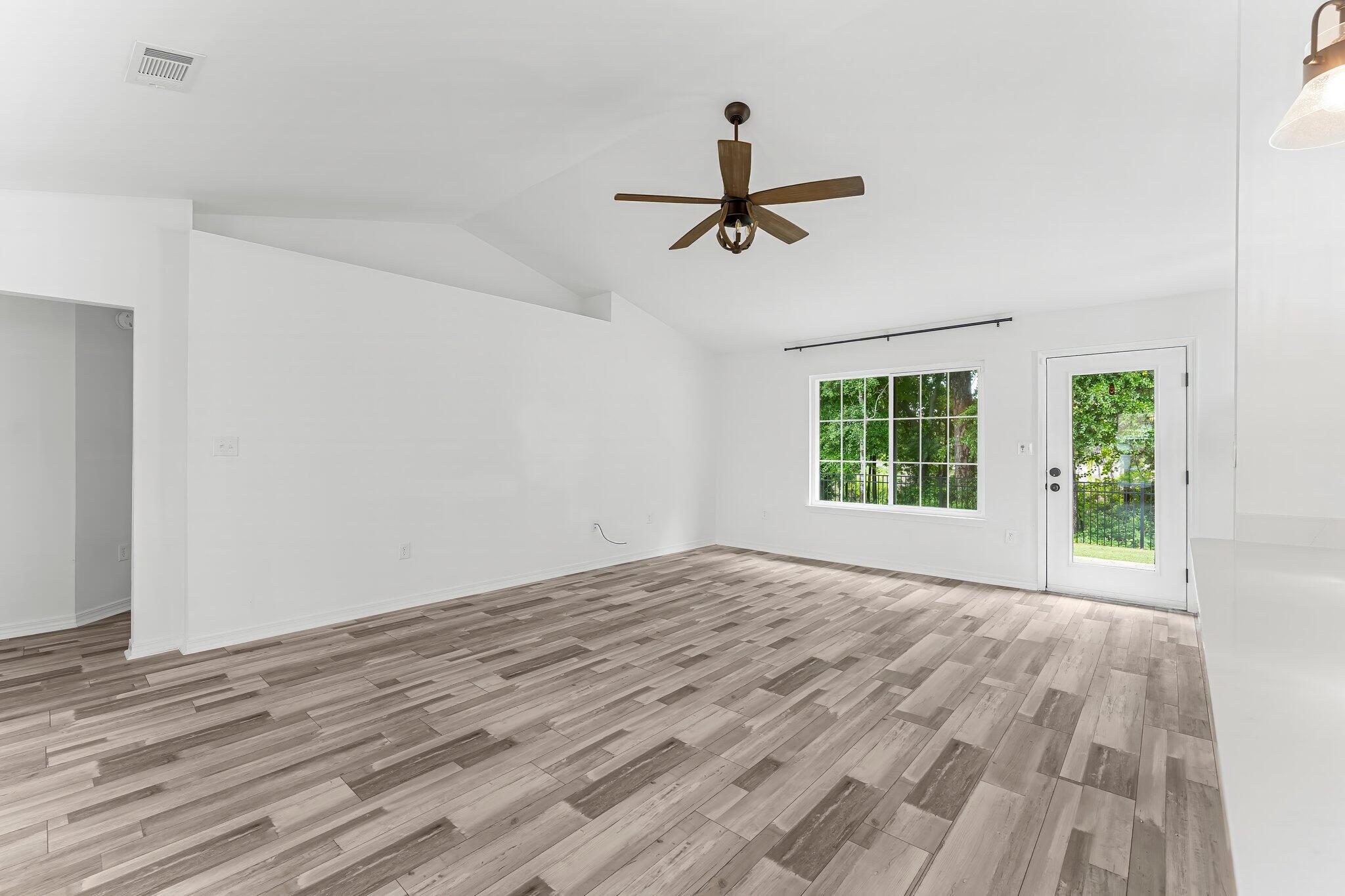 162 Beacon Way Santa Rosa Beach, FL 32459 - Photo 7 of 41 a view of empty room with wooden floor and fan