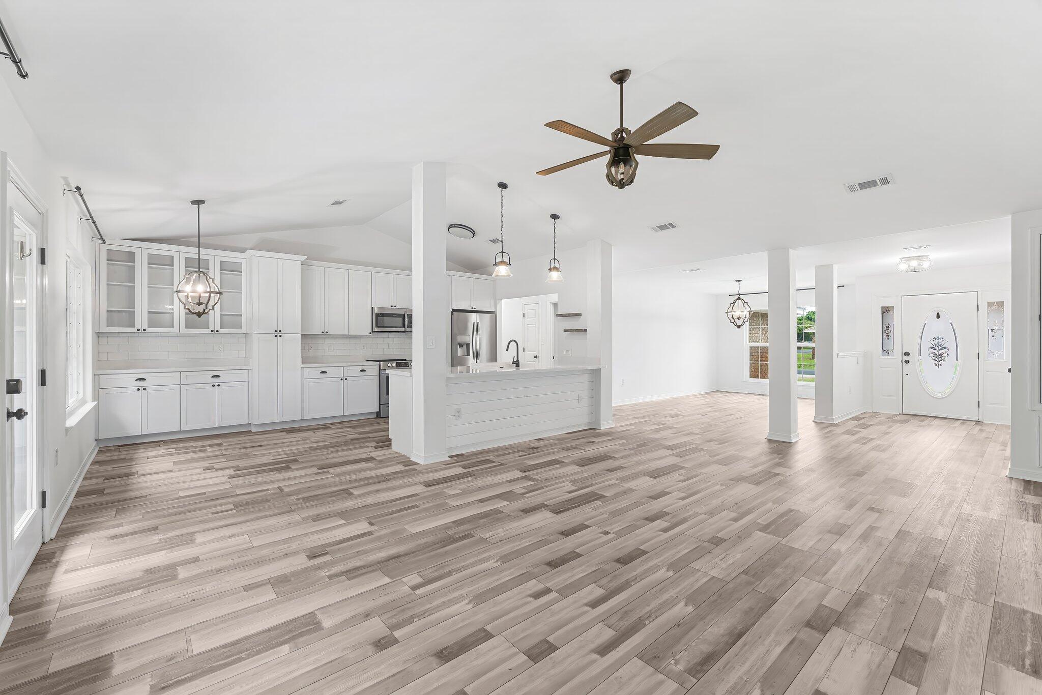162 Beacon Way Santa Rosa Beach, FL 32459 - Photo 9 of 41 a view of a big room with wooden floor and windows