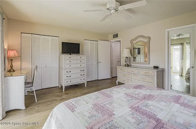 a bedroom with a bed and a television