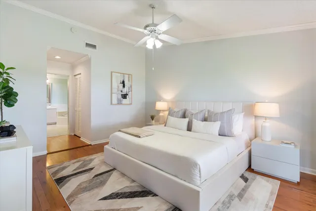 a bedroom with a large bed and a chandelier