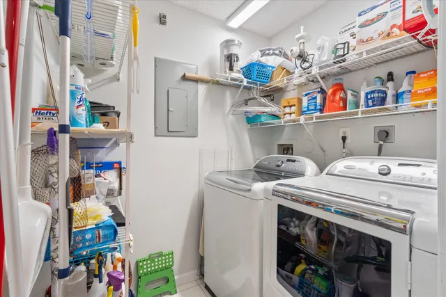a utility room with fridge dryer and bicycles