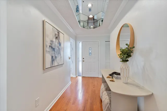 a view of a livingroom with a furniture wooden floor a chandelier