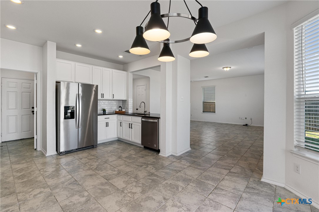 204 Benmyrtle Trail Georgetown, TX 78626 - Photo 13 of 35 a view of a kitchen with a sink and stainless steel appliances