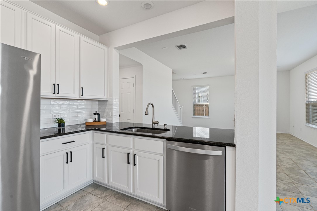204 Benmyrtle Trail Georgetown, TX 78626 - Photo 16 of 35 a kitchen with granite countertop a sink and cabinets