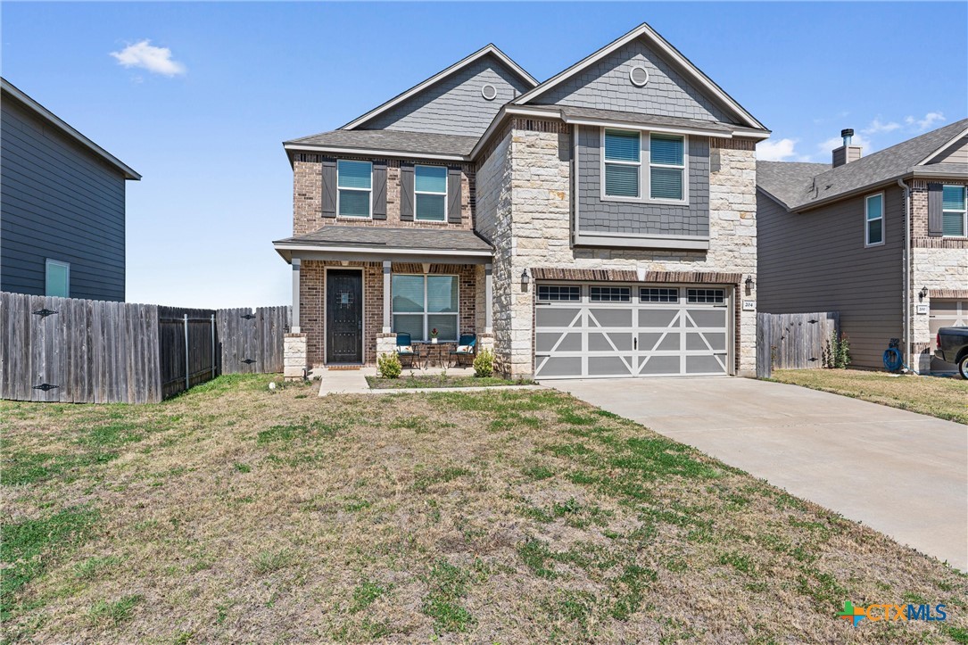 204 Benmyrtle Trail Georgetown, TX 78626 - Photo 2 of 35 a front view of a house with a yard and garage