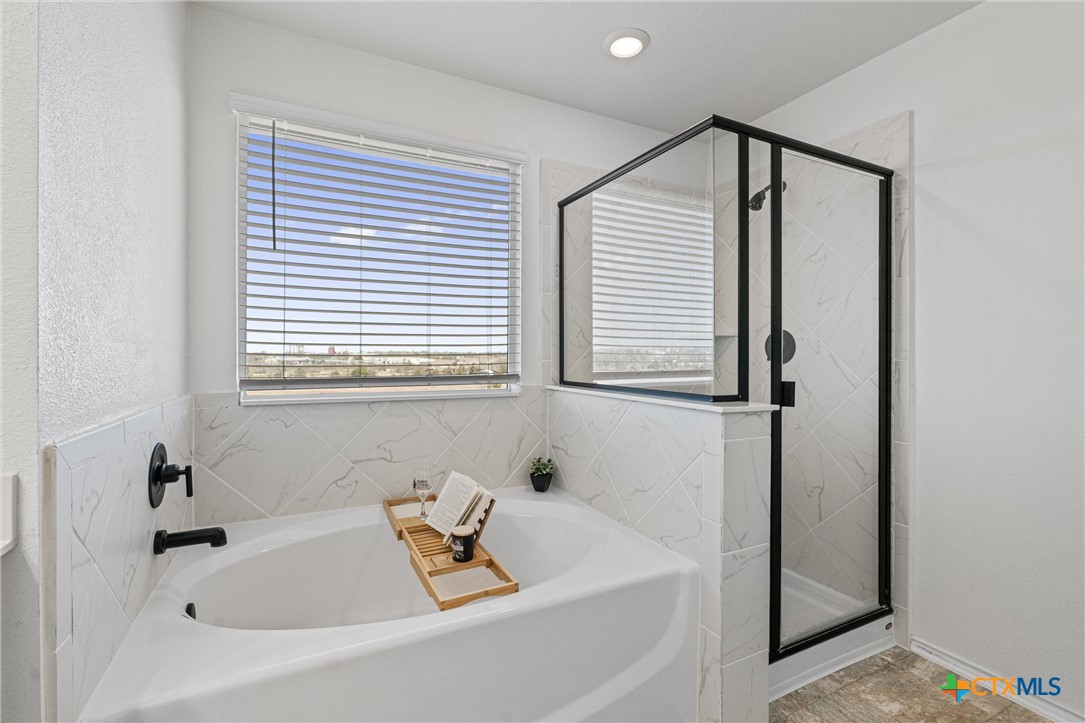 204 Benmyrtle Trail Georgetown, TX 78626 - Photo 24 of 35 a bathroom with a bathtub and a window
