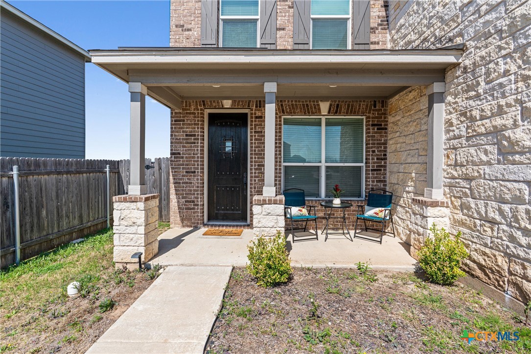 204 Benmyrtle Trail Georgetown, TX 78626 - Photo 3 of 35 a view of a patio with table and chairs with wooden fence and plants
