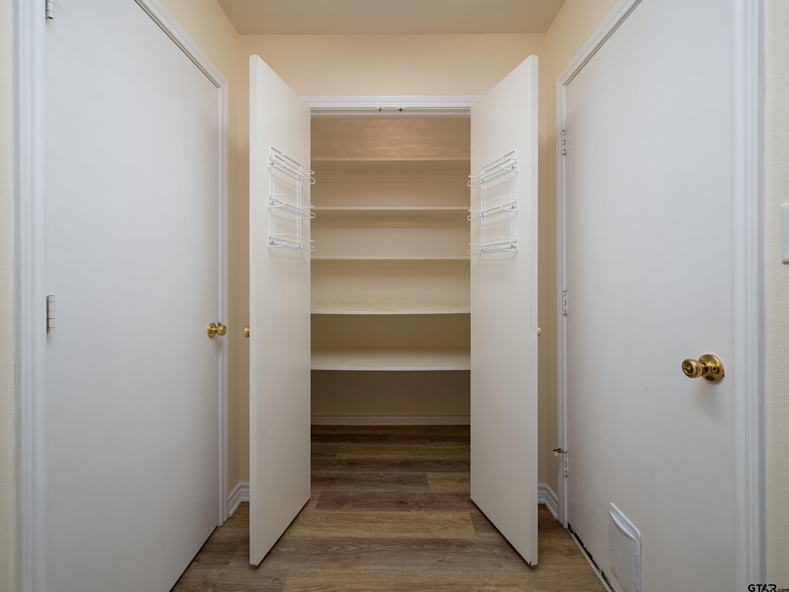 1521 Rice Road Tyler, TX 75703 - Photo 12 of 27 a view of walk in closet with empty racks
