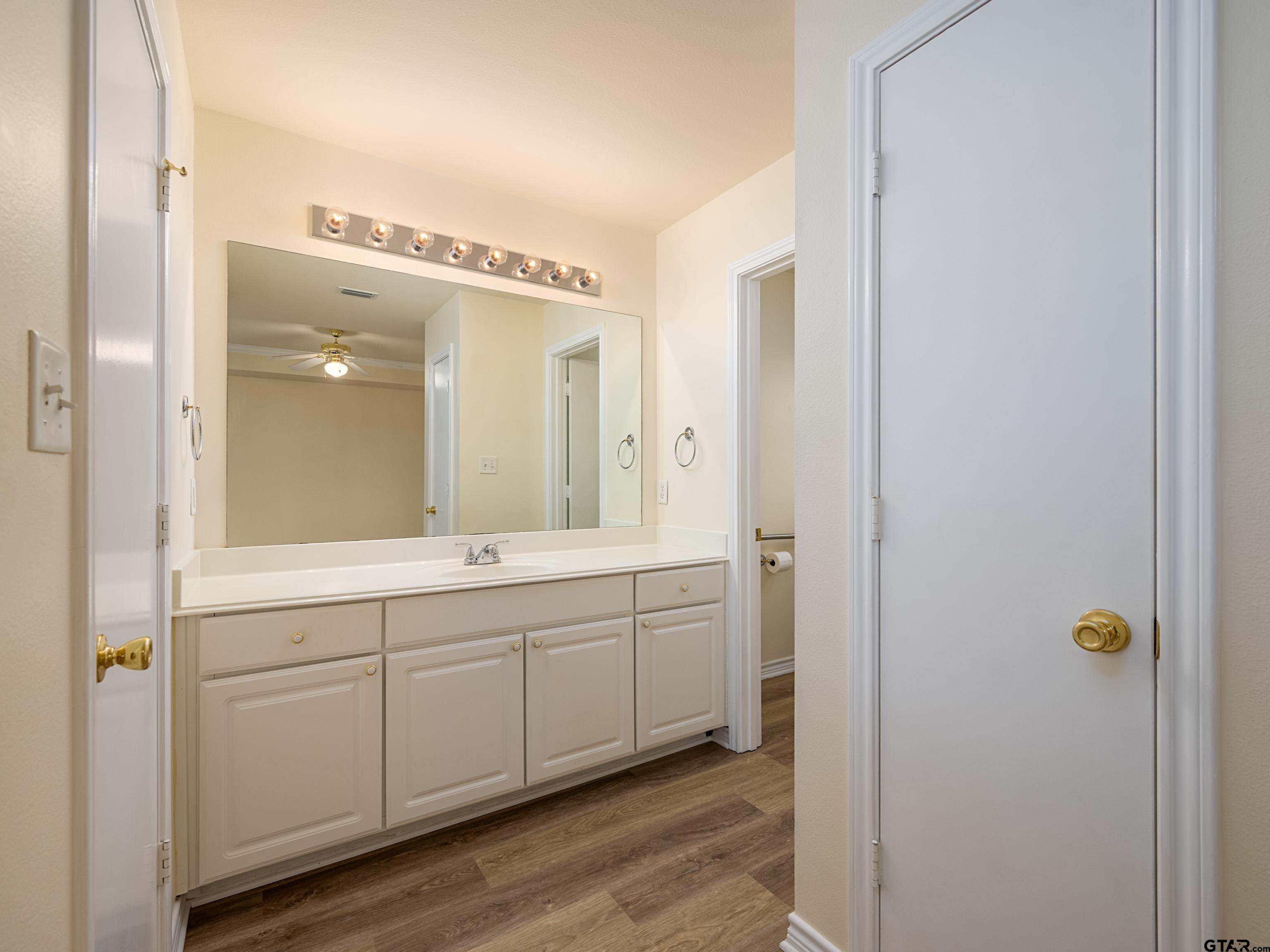 1521 Rice Road Tyler, TX 75703 - Photo 15 of 27 a bathroom with a double vanity sink and mirror