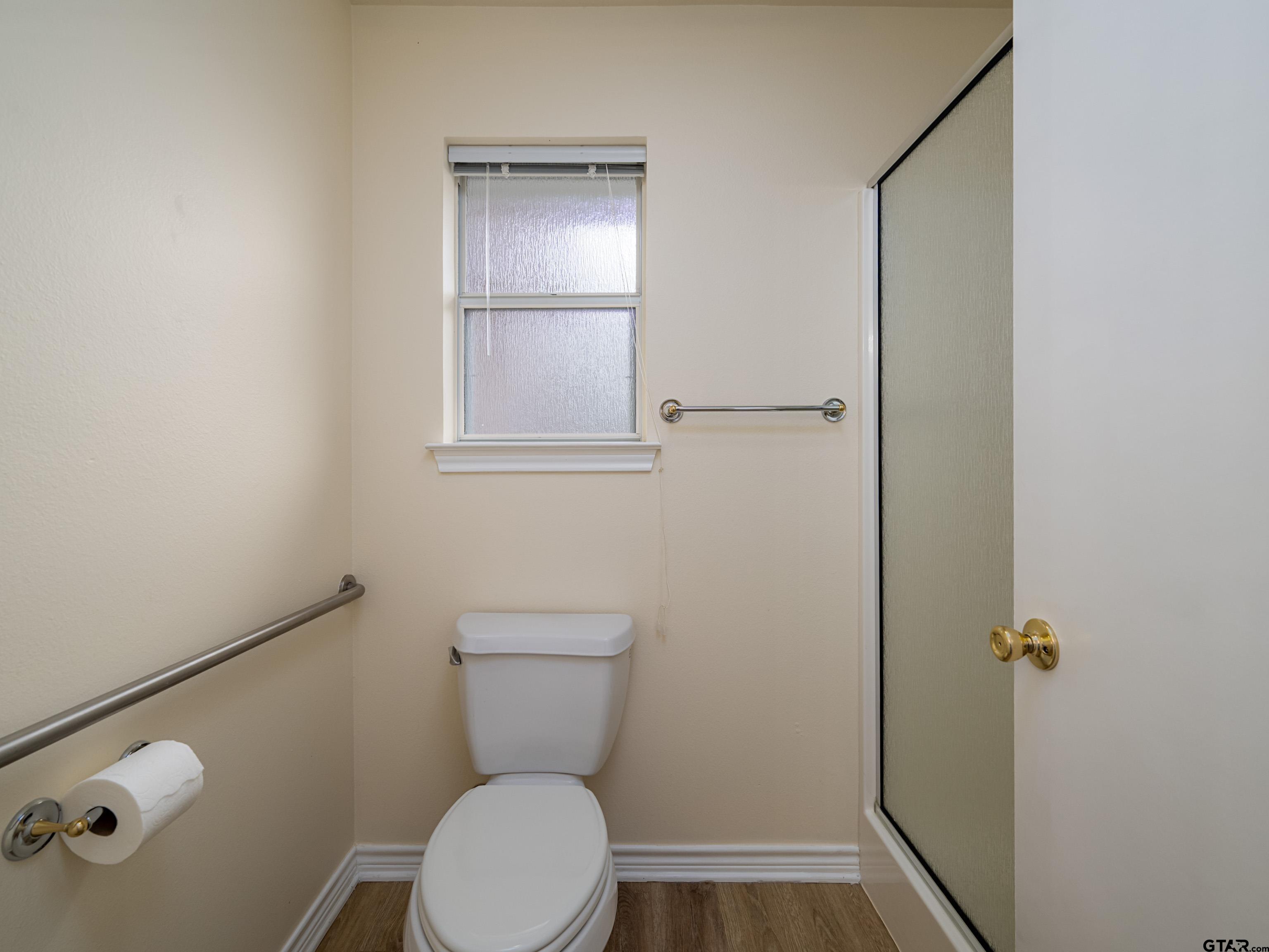 1521 Rice Road Tyler, TX 75703 - Photo 16 of 27 a white toilet sitting next to a bathroom sink
