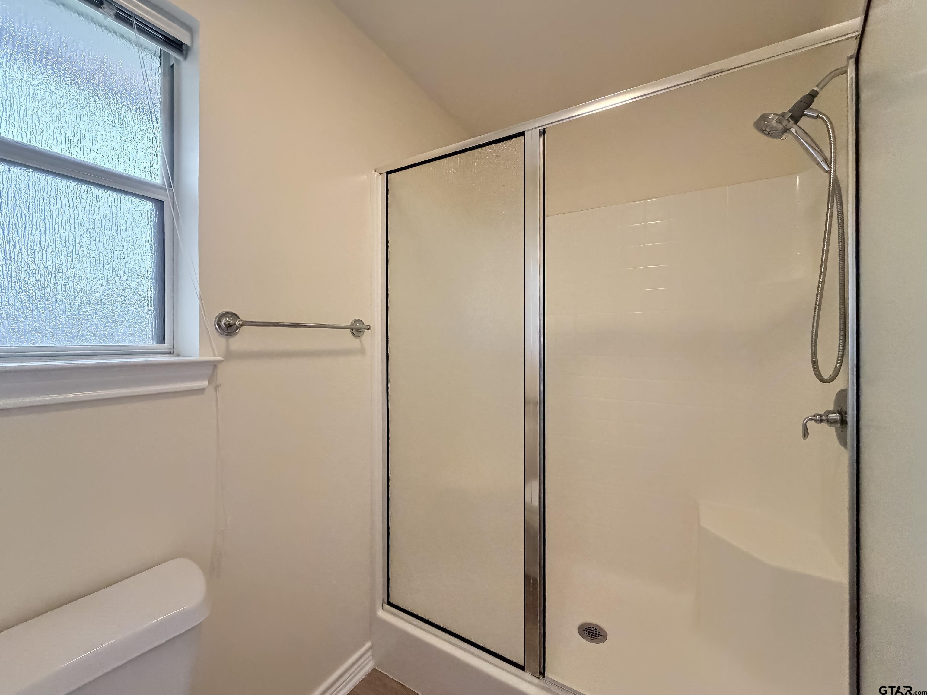1521 Rice Road Tyler, TX 75703 - Photo 17 of 27 a bathroom with a glass shower door