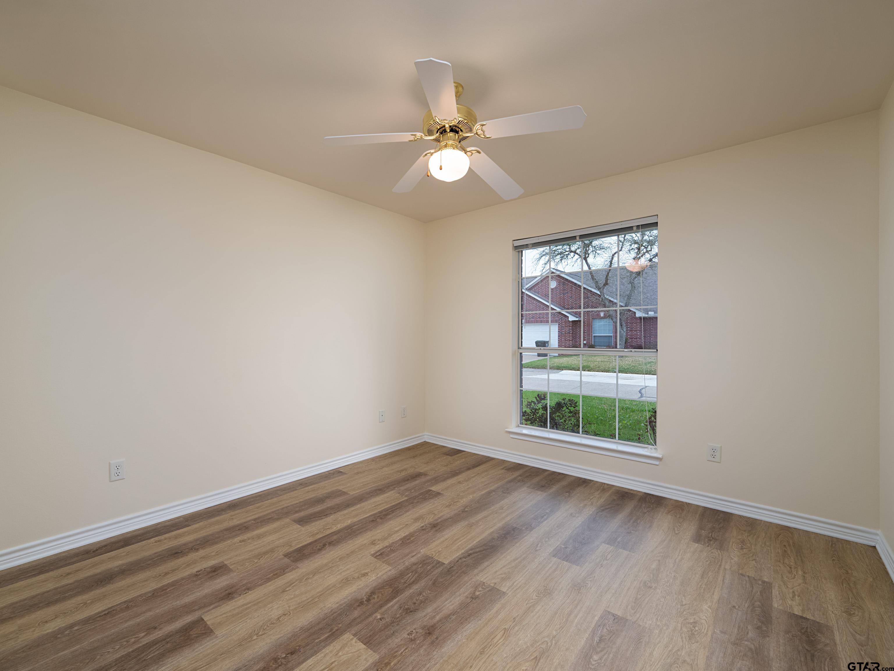 1521 Rice Road Tyler, TX 75703 - Photo 19 of 27 wooden floor in an empty room with a window