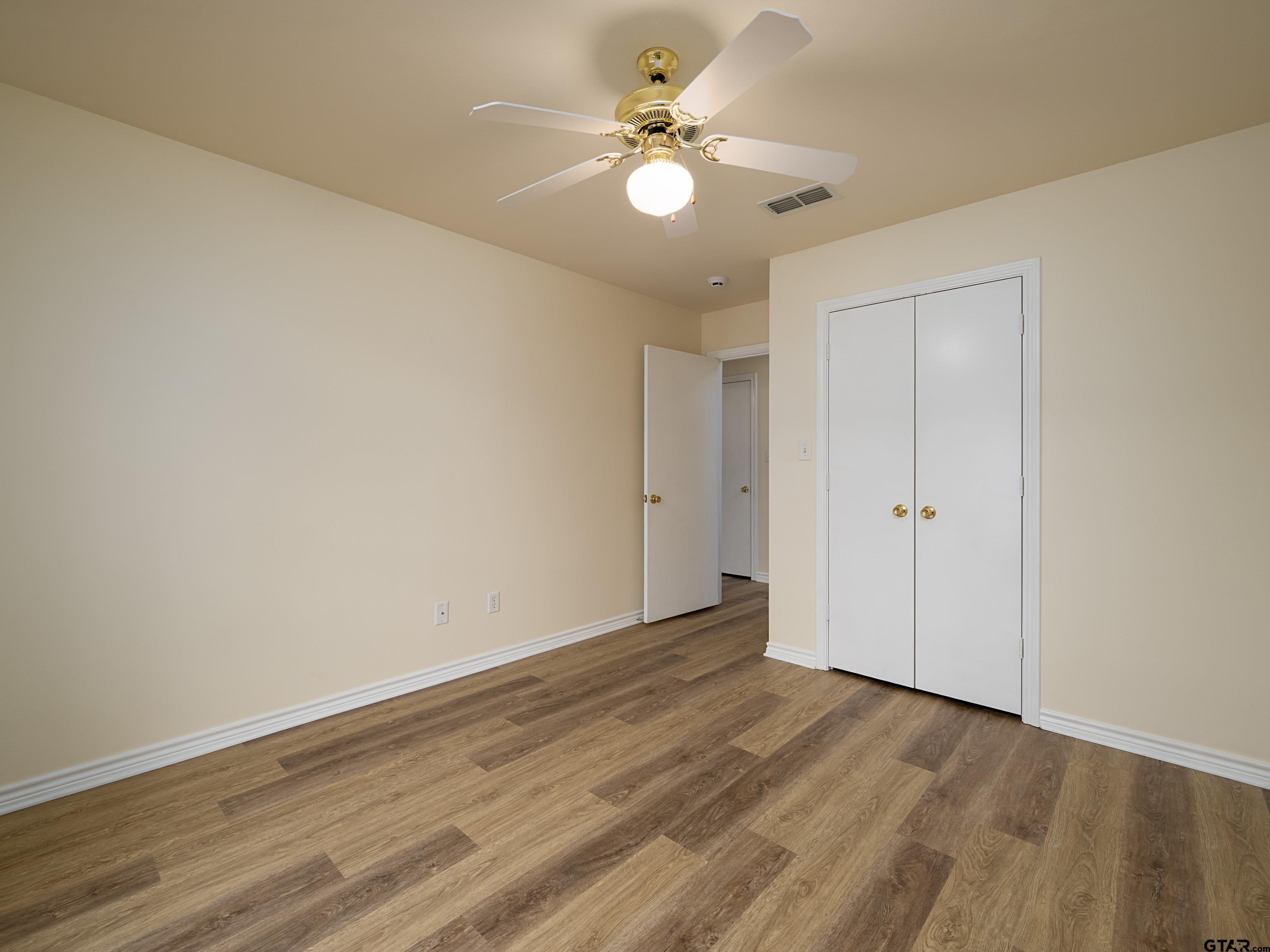 1521 Rice Road Tyler, TX 75703 - Photo 20 of 27 a view of an empty room with closet and a ceiling fan