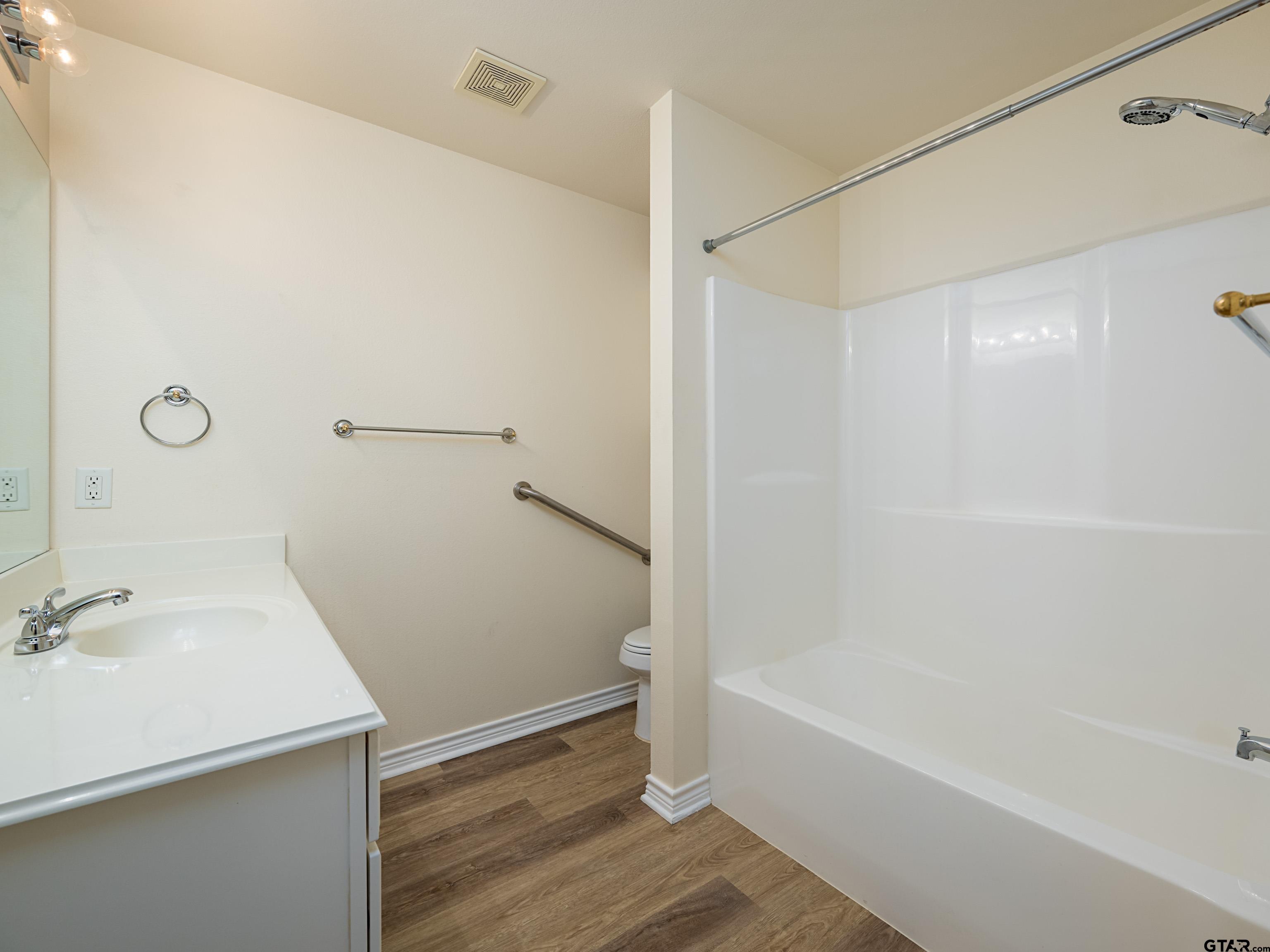 1521 Rice Road Tyler, TX 75703 - Photo 21 of 27 a bathroom with a bathtub and a shower