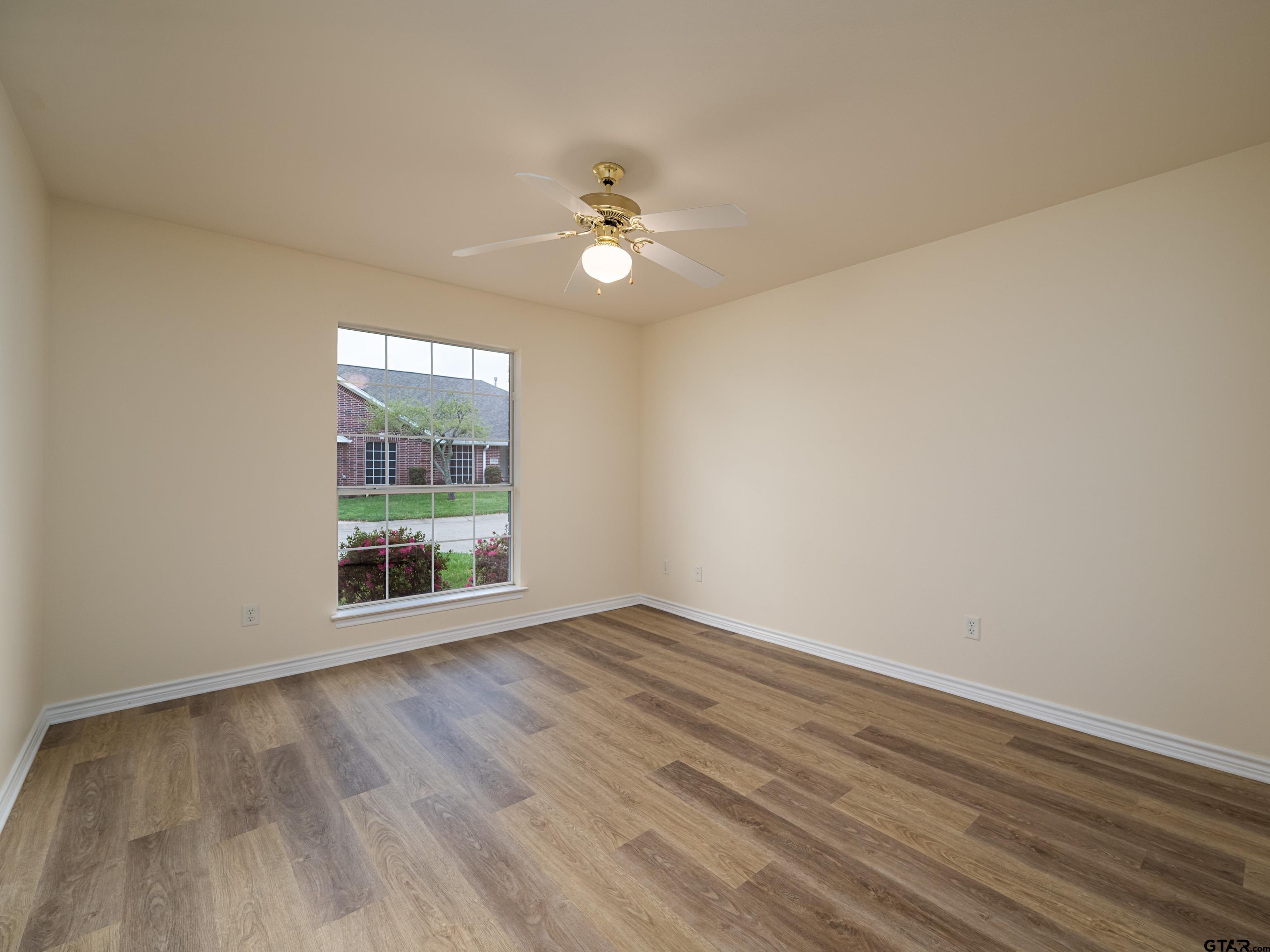 1521 Rice Road Tyler, TX 75703 - Photo 23 of 27 wooden floor in an empty room with a window
