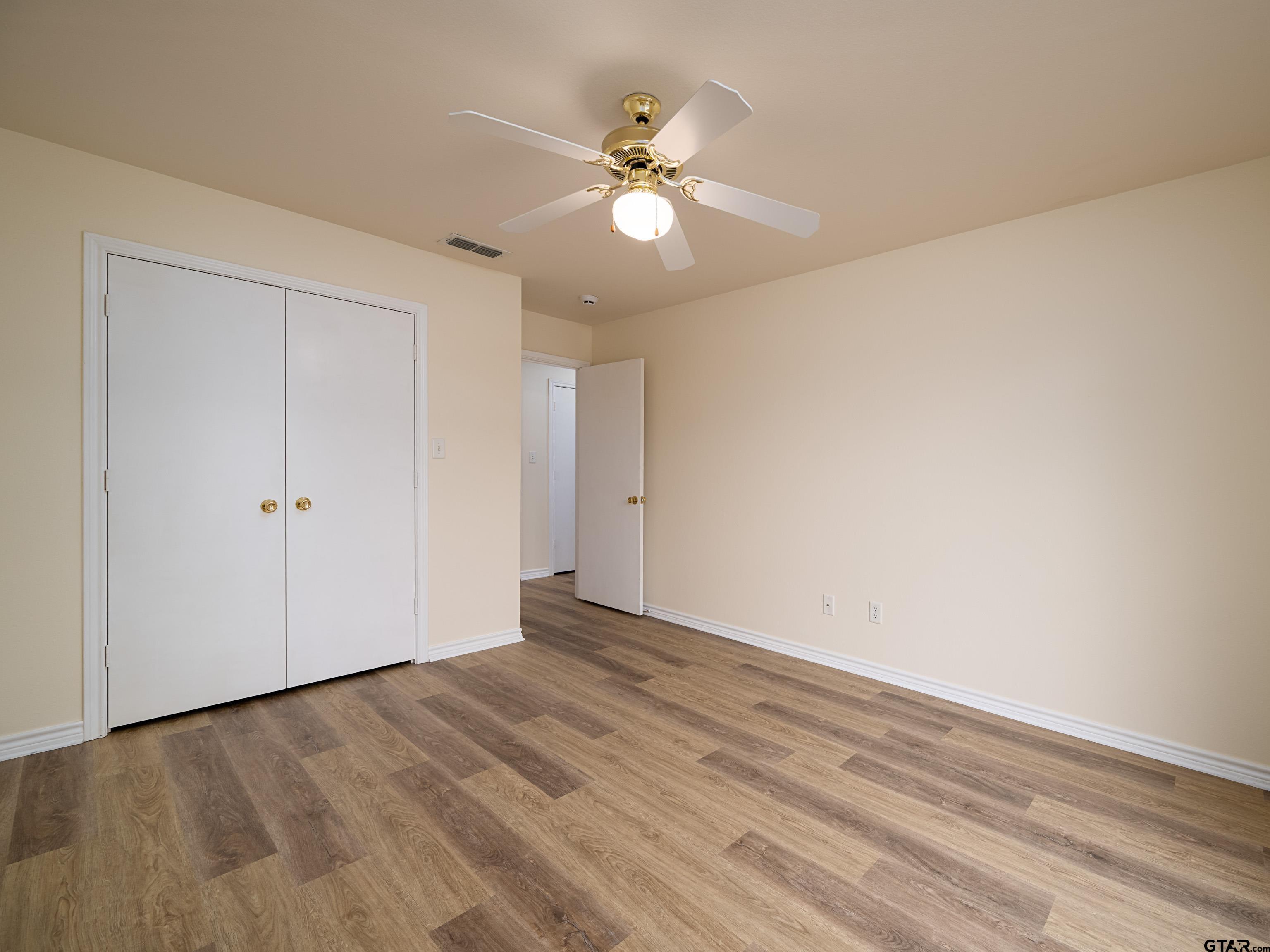 1521 Rice Road Tyler, TX 75703 - Photo 24 of 27 a view of an empty room with wooden floor