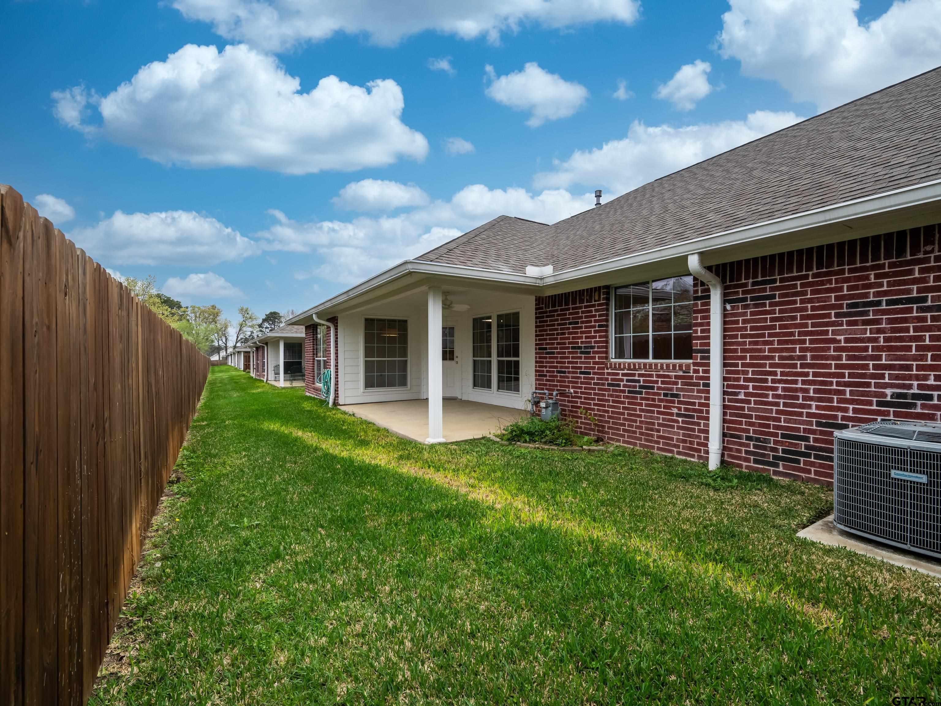 1521 Rice Road Tyler, TX 75703 - Photo 27 of 27 a view of a backyard with plants and large tree