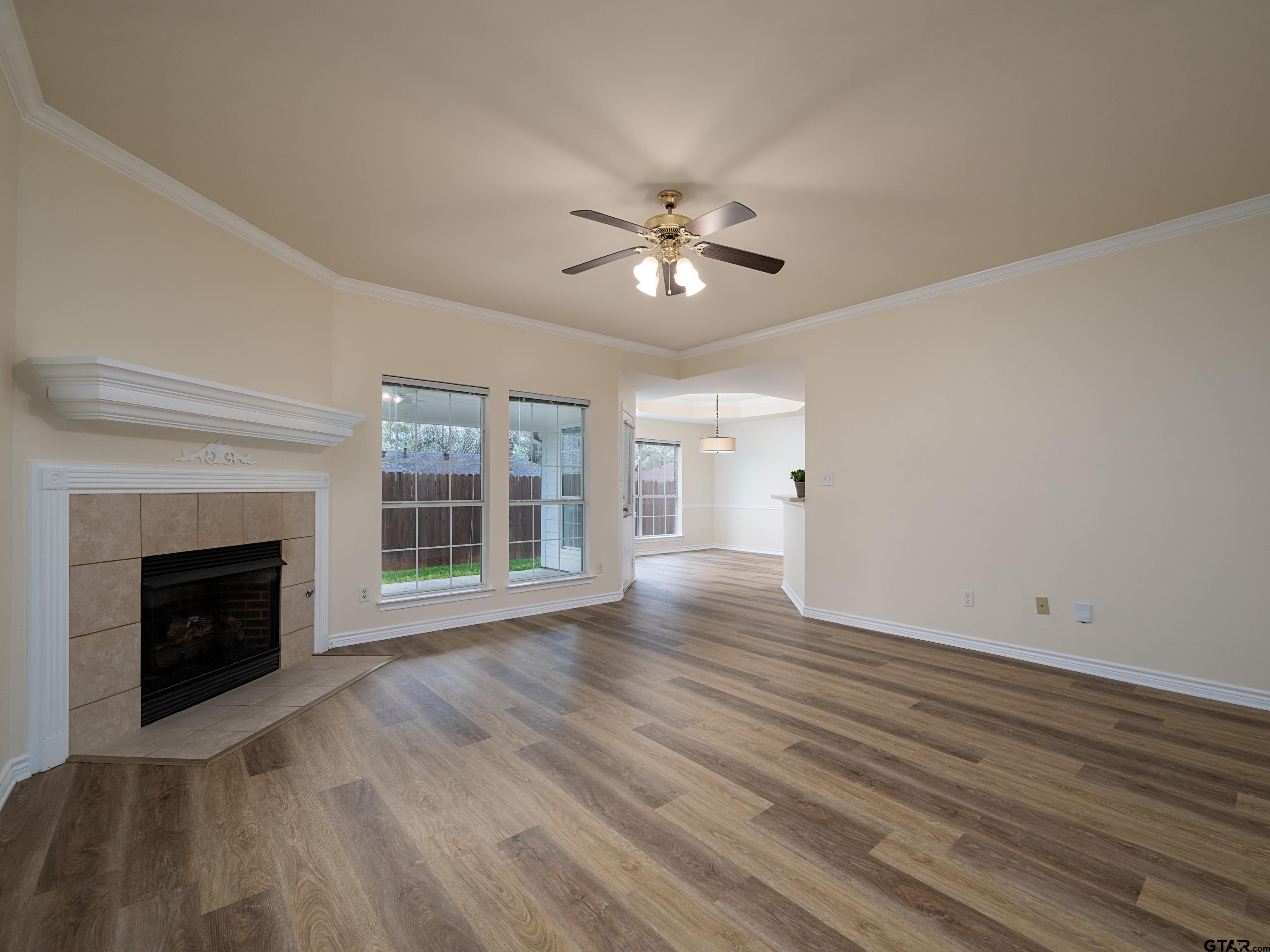 1521 Rice Road Tyler, TX 75703 - Photo 4 of 27 a view of empty room with wooden floor and fan