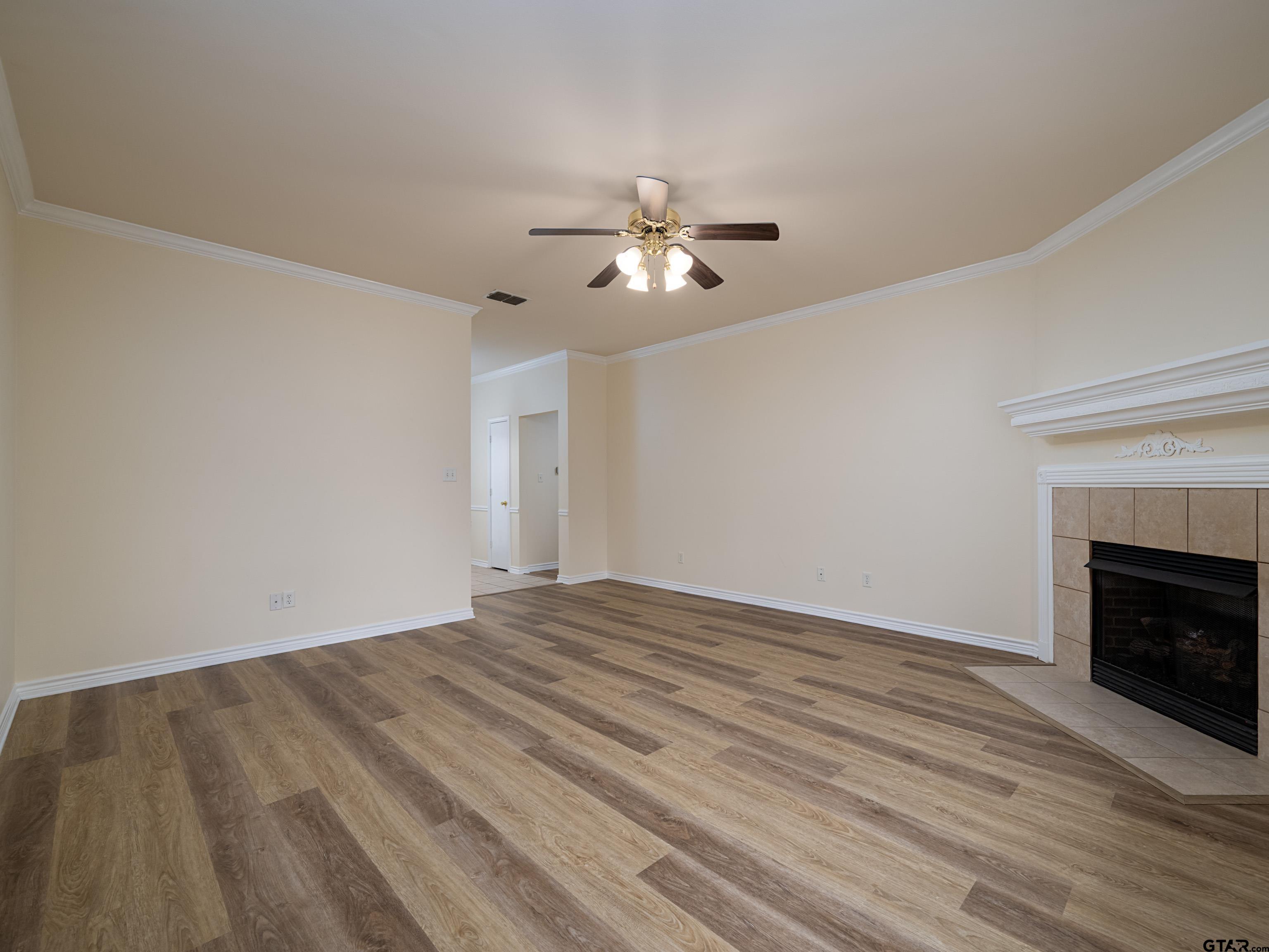 1521 Rice Road Tyler, TX 75703 - Photo 6 of 27 a view of empty room with wooden floor and fan