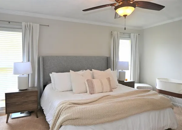 a bedroom with a bed and a lamp