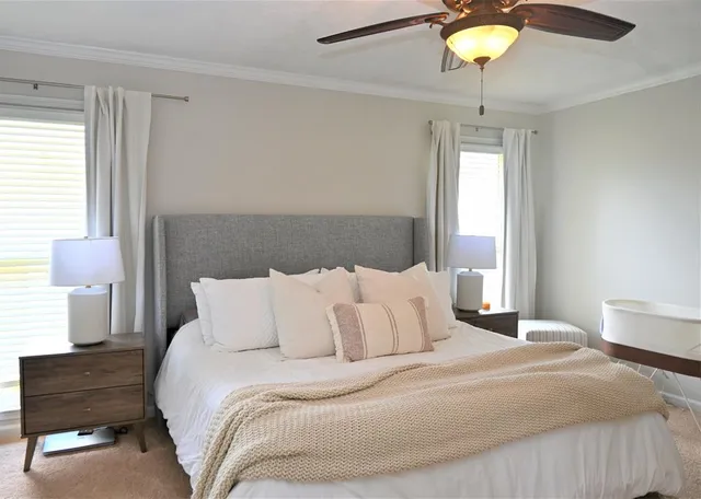 a bedroom with a bed and a lamp