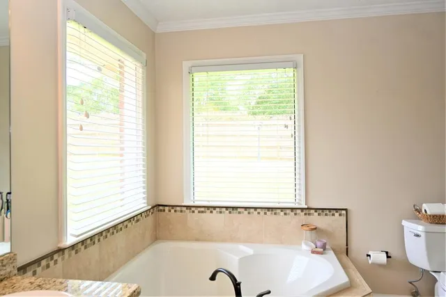 a bathroom with a tub and a window