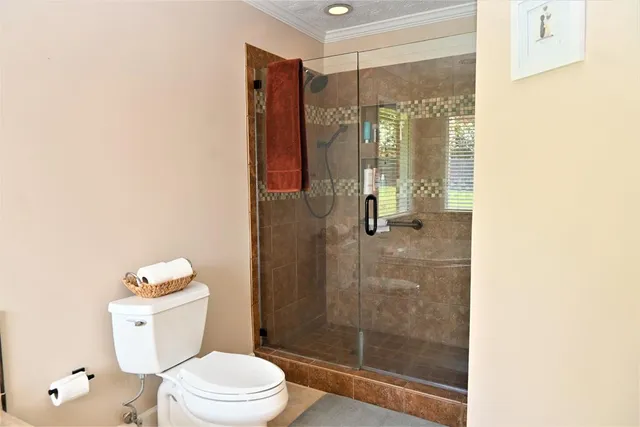 a bathroom with a shower a toilet and a sink