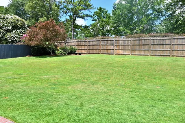 a view of outdoor space with deck and yard
