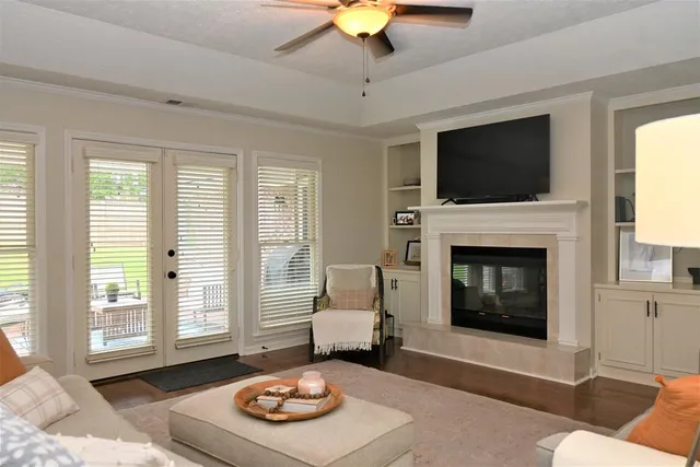 a living room with furniture a flat screen tv and a fireplace
