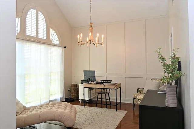 a bedroom with furniture and a chandelier
