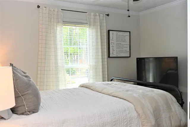 a bedroom with a bed and a painting on the wall